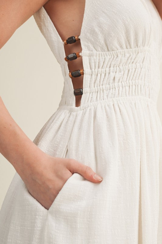 SLEEVELESS SIDE BUTTON SMOCKED WAIST MIDI DRESS WITH BEAD DETAIL