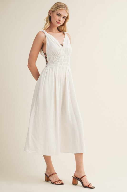 SLEEVELESS SIDE BUTTON SMOCKED WAIST MIDI DRESS WITH BEAD DETAIL