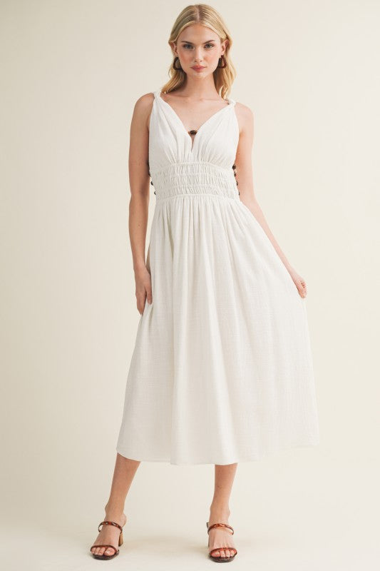 SLEEVELESS SIDE BUTTON SMOCKED WAIST MIDI DRESS WITH BEAD DETAIL