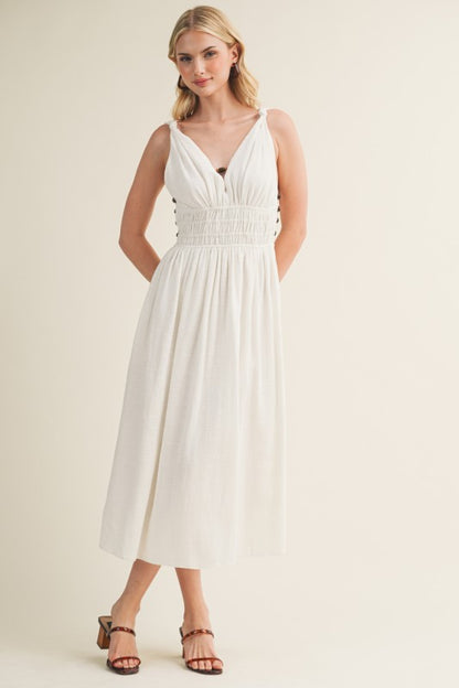 SLEEVELESS SIDE BUTTON SMOCKED WAIST MIDI DRESS WITH BEAD DETAIL