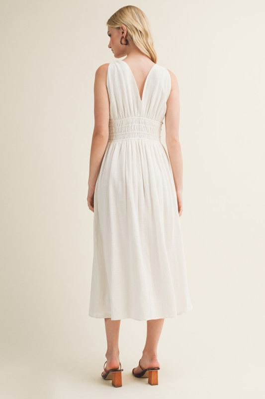 SLEEVELESS SIDE BUTTON SMOCKED WAIST MIDI DRESS WITH BEAD DETAIL